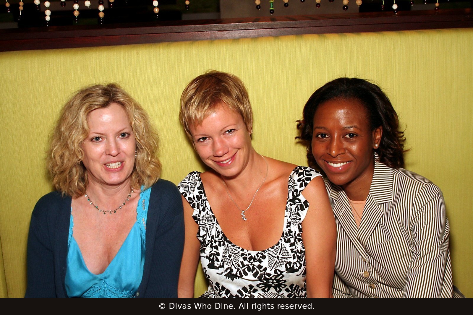Three Original Divas seated together at a New York City Divas Who Dine gathering in June 2006