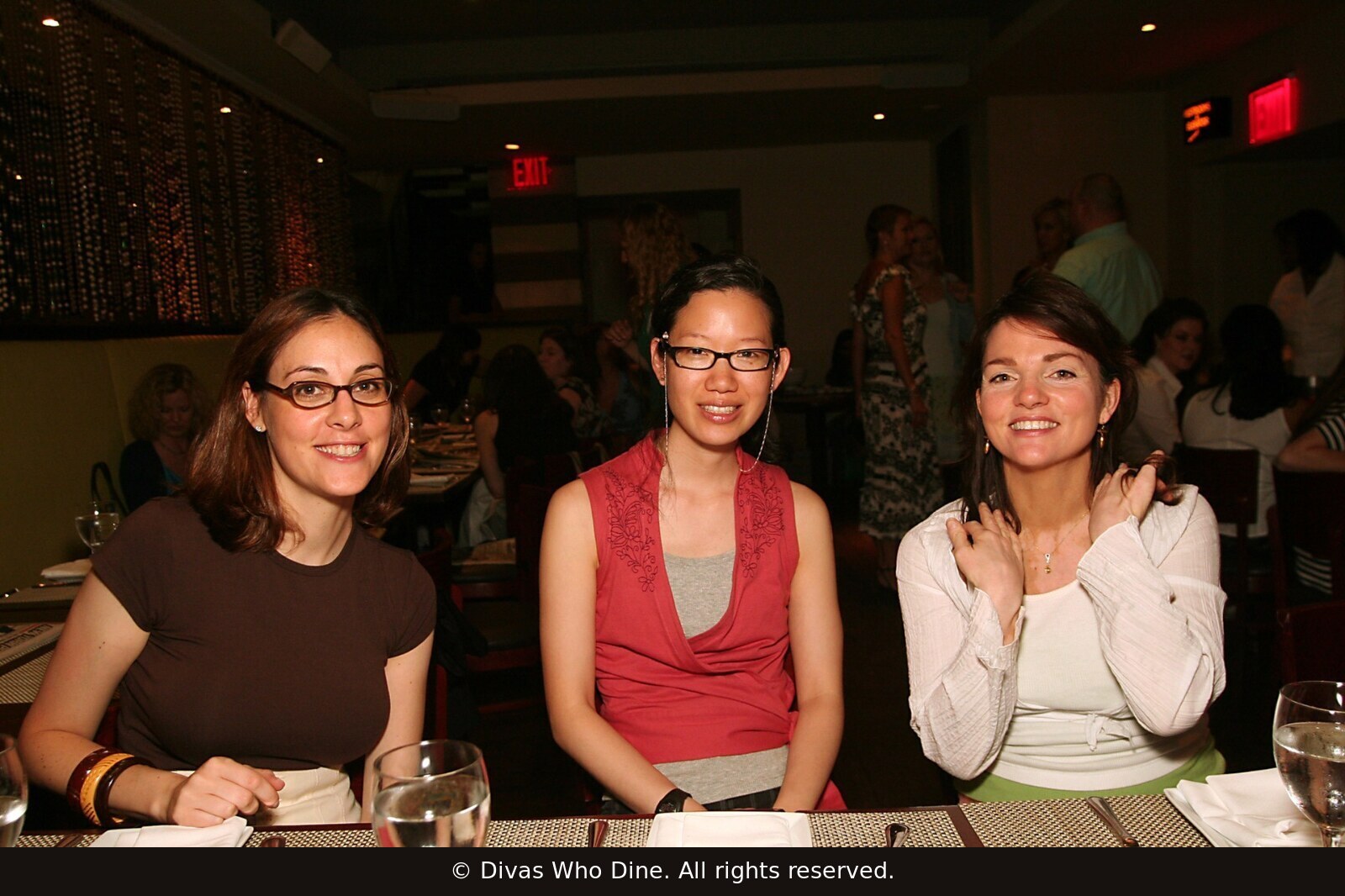 Three women in conversation at a New York City Divas Who Dine gathering in June 2006